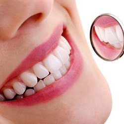 Close up of woman’s smile and dental mirror